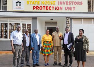 Col. Edith Nakalema takes a group photo with Board and Management of the Kalangala Palm Oil Growers Trust